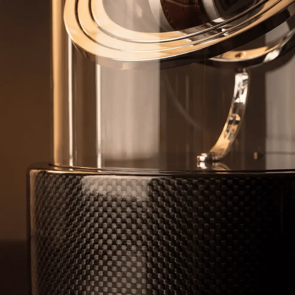 Black Astronome Comète watch winder in carbon fibre with glass dome and silver metal details for an automatic watch.