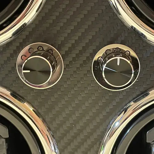 Rotary control knobs on a black carbon fibre Gioco Carbone watch winder with chrome finishes.