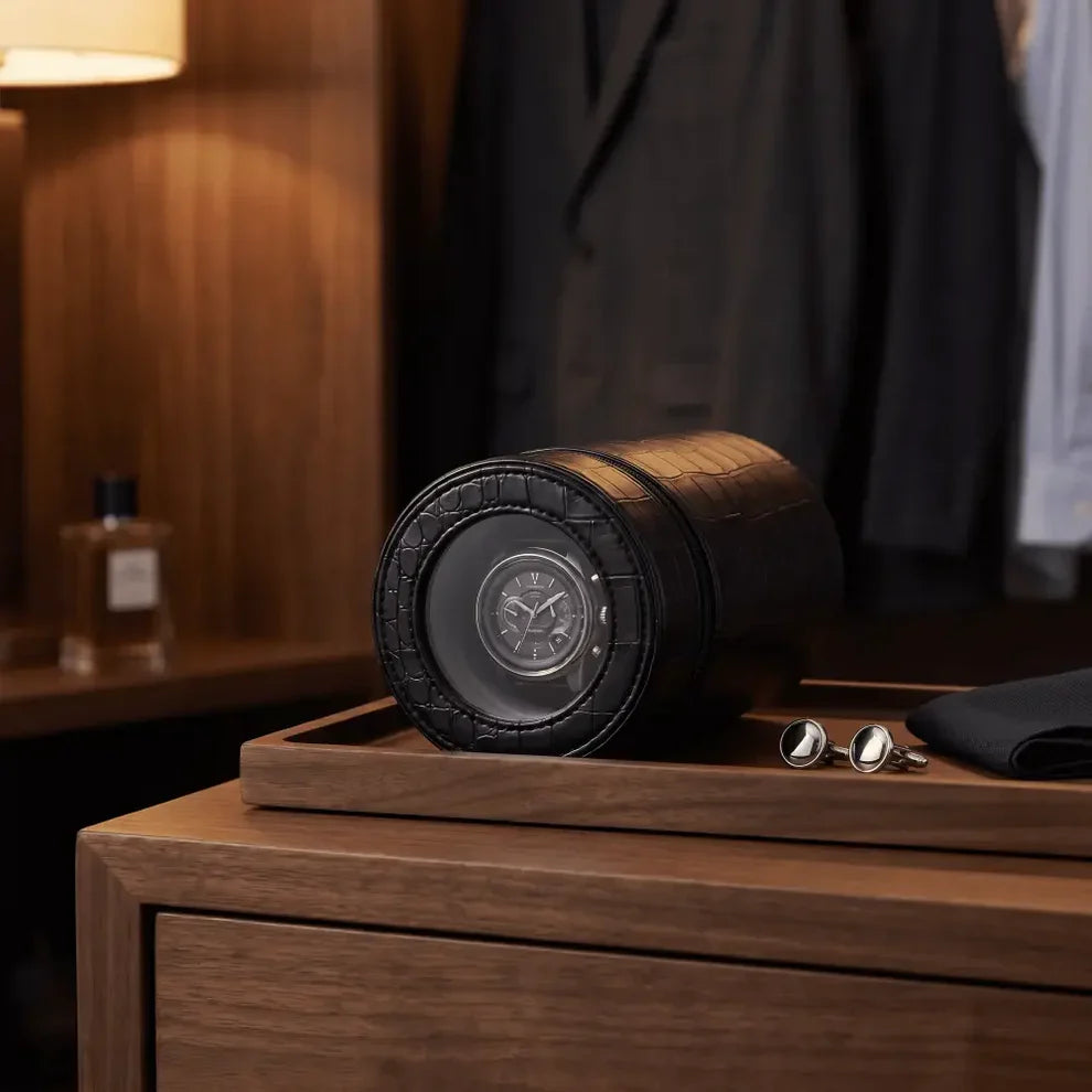 Black Rocket travel winder in crocodile-effect faux leather with automatic watch, set on a wooden tray.