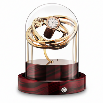 Gold Astronome Prestige automatic watch winder under a glass dome with red and black wooden base.