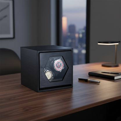 Black aluminium Cube Prestige watch winder with two slots for automatic watches on a wooden desk.
