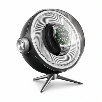 Tripode Solo black watch winder with a modern spherical design, tripod stand and an automatic watch with a green dial.