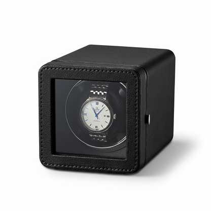 Black cube-shaped automatic watch winder with textured finish and transparent viewing window.
