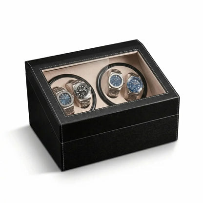 Black leather watch winder with glass lid, 4 motorised slots for automatic watches and beige suede interior.