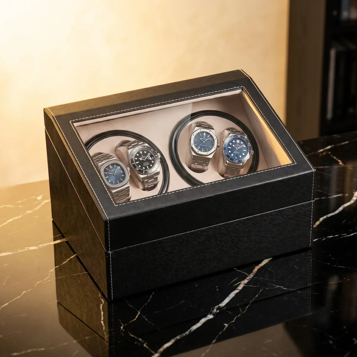 Black leather watch winder with glass lid, 4 motorised slots and beige interior for automatic watches.