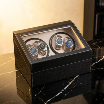 Black leather watch winder with glass lid, 4 motorised slots and beige interior for automatic watches.