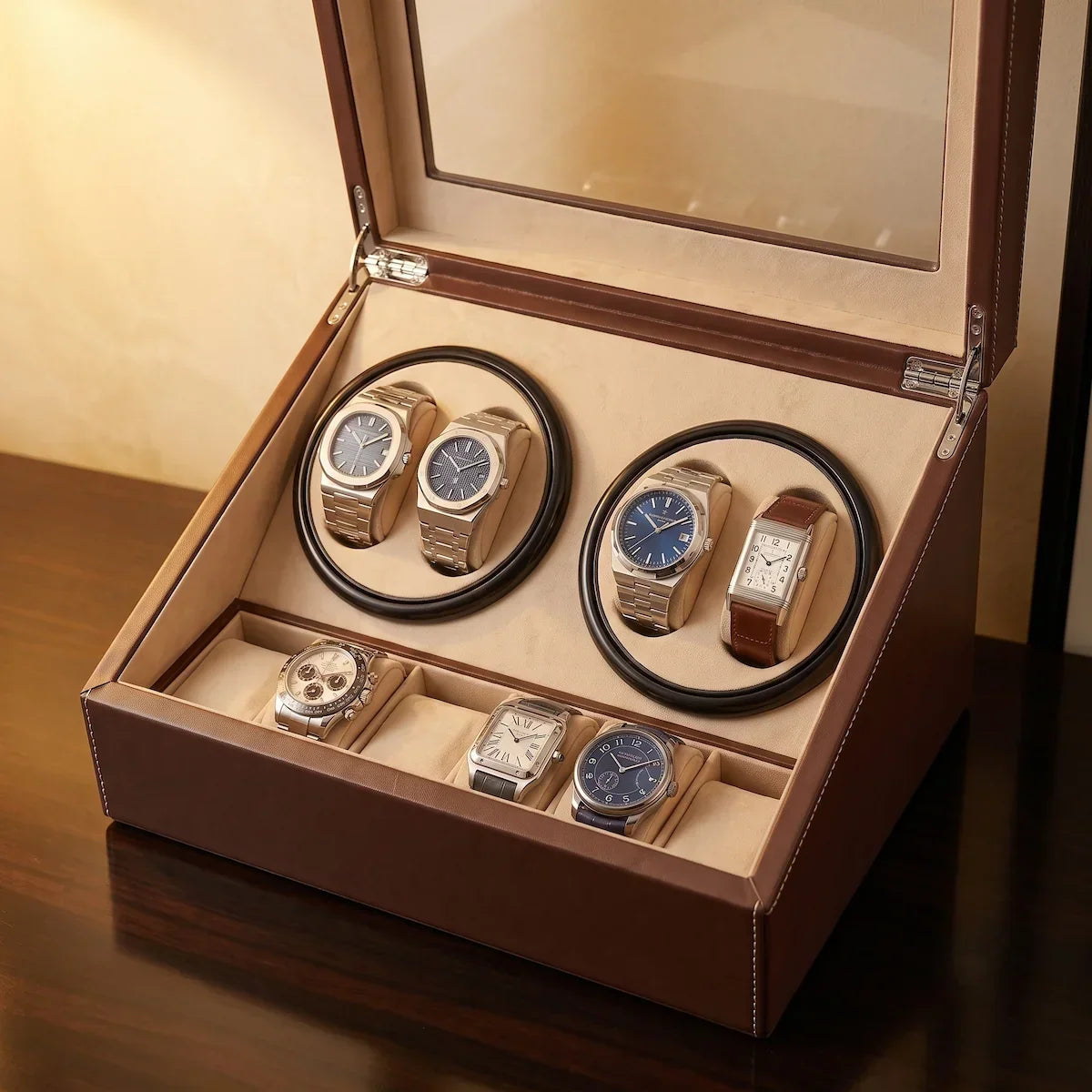 Brown leather watch winder with 4 rotors, 6 storage slots and glass lid for automatic watches.