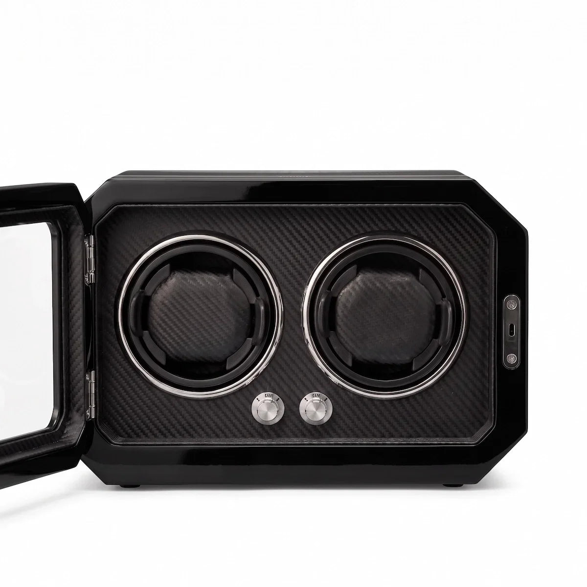 Watch winder for 2 watches in black carbon fibre with a glass door, LED lighting and rotary control knobs.