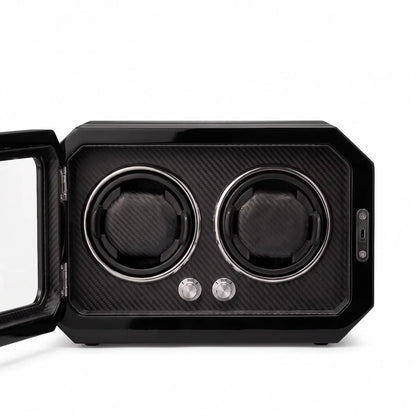 Watch winder for 2 watches in black carbon fibre with a glass door, LED lighting and rotary control knobs.