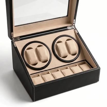 Black leather watch winder with glass lid, 4 rotating slots and 6 beige interior storage compartments.