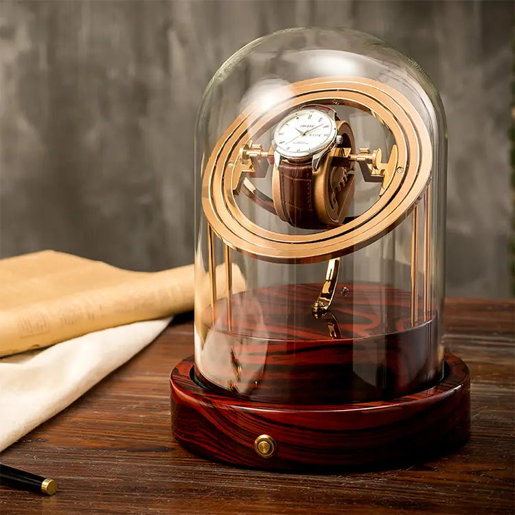 Gold and red wood Astronome Prestige automatic watch winder under a glass dome for one watch.